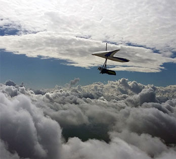 Hang glide above the clouds